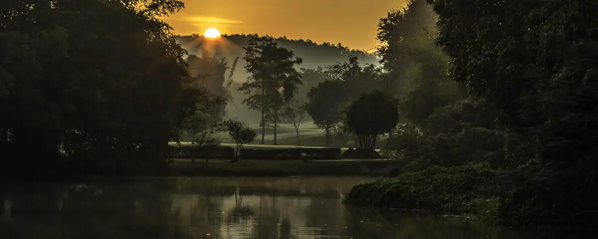 The sun rises over a misty Royal Chiang Mai Golf Club