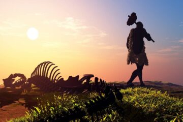 primitive man in his environment walking away from an animal skeleton at sunrise