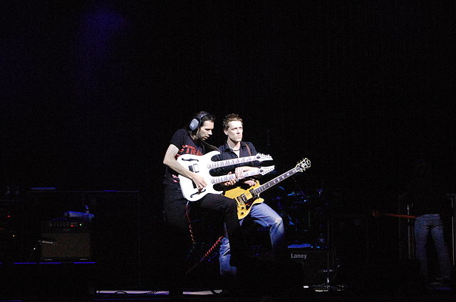 most skilled guitarist Paul Gilbert playing duo with double-neck gitar in concert
