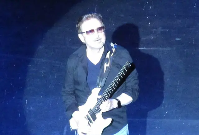 Buck Dharma of Blue Oyster Cult playing guitar in spotlight
