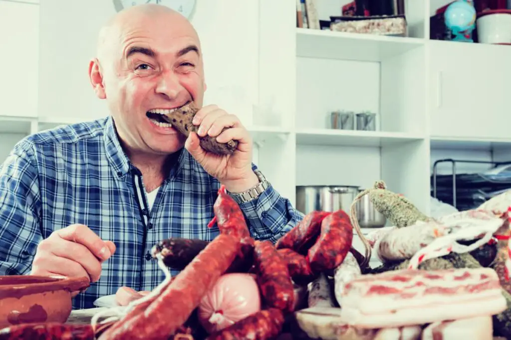 portrait of ordinary men with lots of meat and sausage products