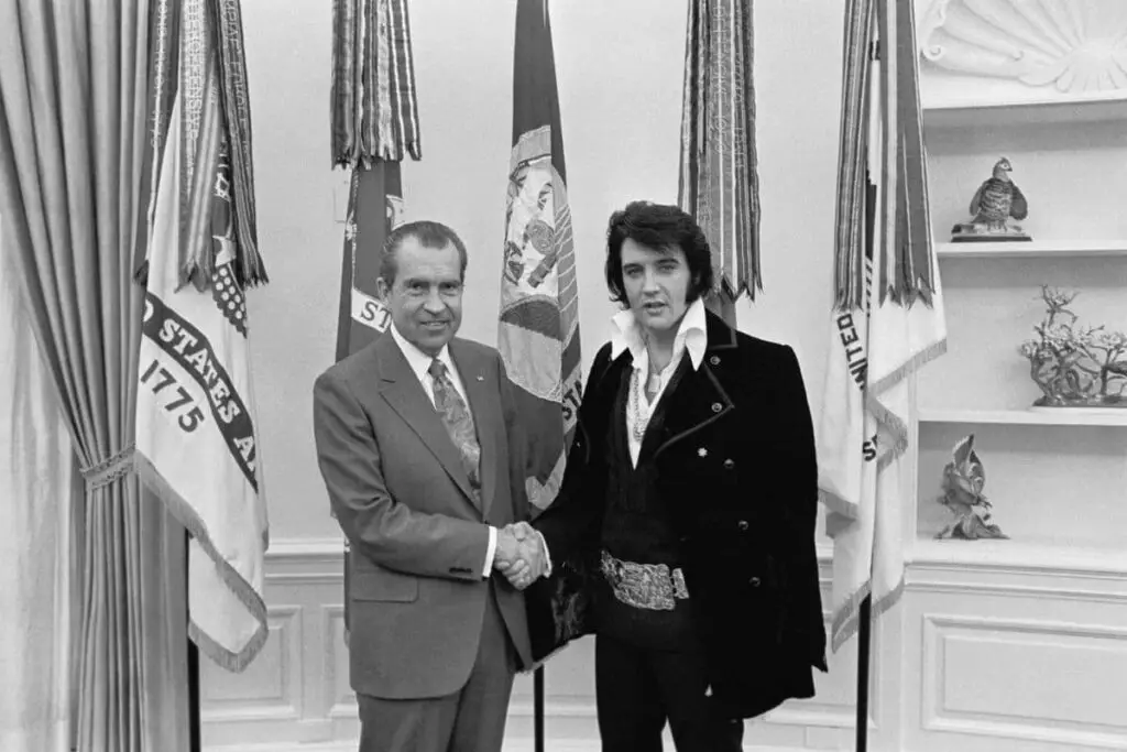 Most influential musician, Elvis Presley shakes President Nixon's hand in the Oval Office while posing for the camera
