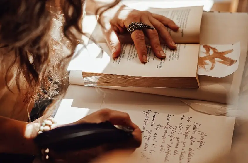 woman writing in ink in her journal - Pexels, Furkanfdemir, https://www.pexels.com/photo/faceless-woman-writing-using-ink-7080728/