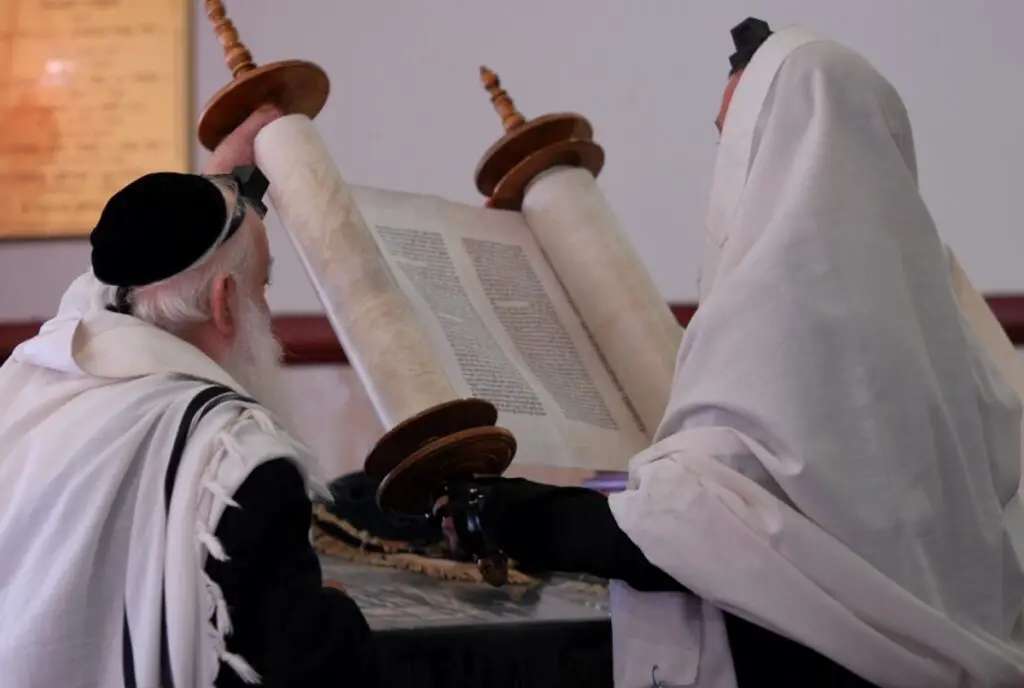 A rabbi in Israel reads from a Torah scroll. - "File:PikiWiki Israel 16920 Torah Reading.JPG" by מנחם מנחמי
