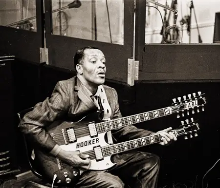 Photo of Earl Hooker playing double neck guitar - Image source: https://www.vintageguitar.com/40622/fretprints-earl-hooker/