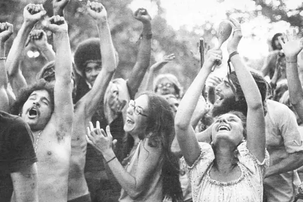 iconic photo of a group of revellers happy at Woodstock '69 - https://www.pastchronicles.com/legendary-woodstock-photos-that-will-go-down-in-history/