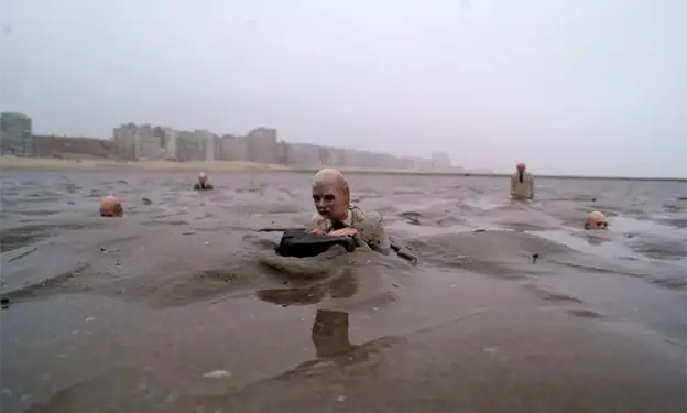 Men in suits in the water - Image Source: https://artistsandclimatechange.com/2014/05/11/waiting-for-climate-change/