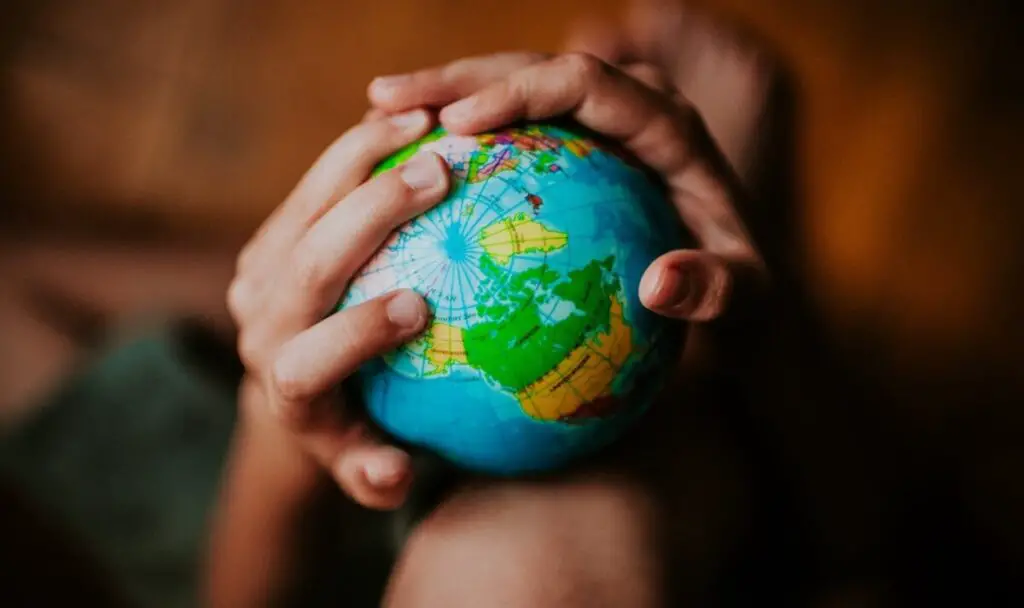 Photo of a globe in a childs hands