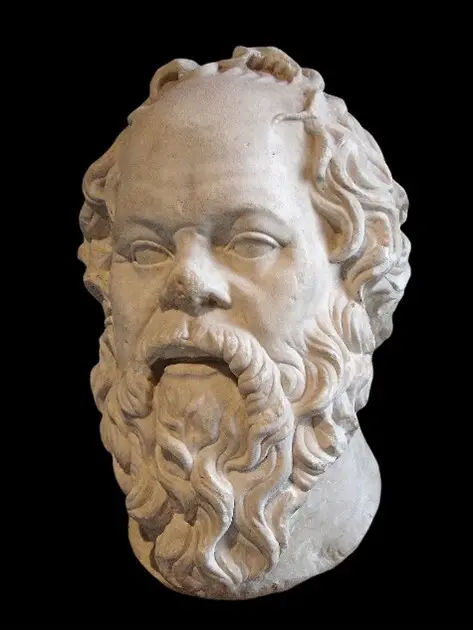 White sculpture of Socrates head. Black background.