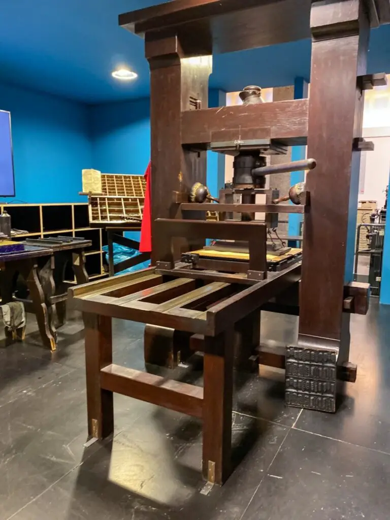 Photo of Gutenberg Press centre middle ground with blue walls background