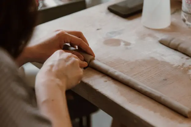 sculptor cutting clay - https://www.pexels.com/photo/close-up-of-woman-working-with-clay-8063874/