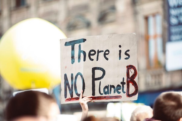 Protester holding up a placard saying there is no Planet B