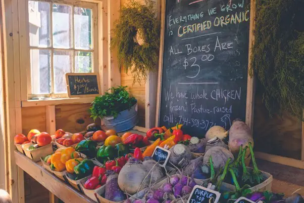 a photo of a table of raw organic veggies in a shop