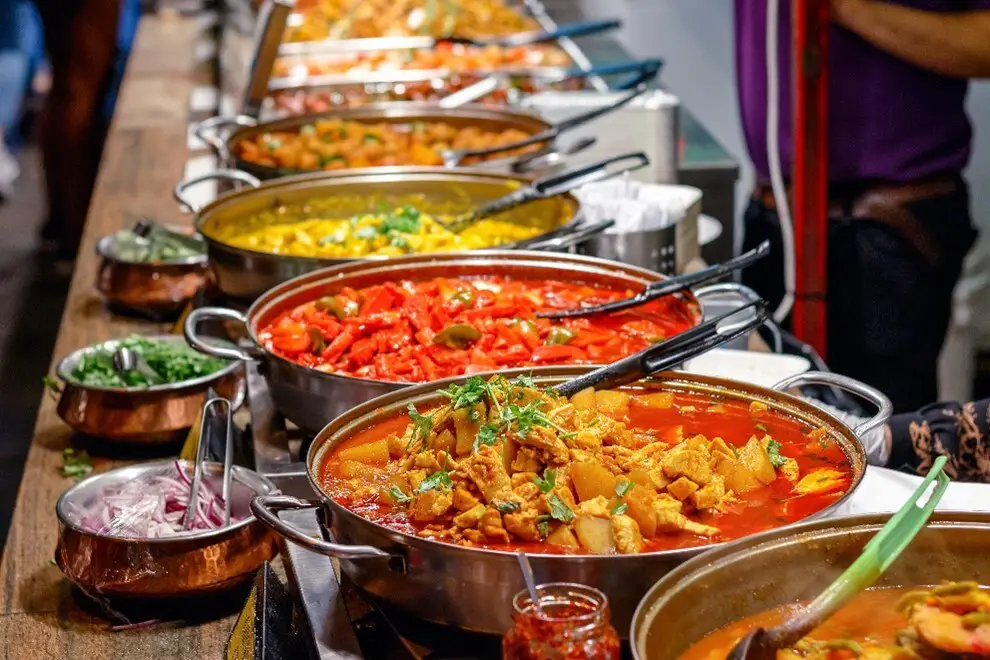 Photo: I Wei Huang/Shutterstock. Variety of cooked curries on display at Camden Market in London