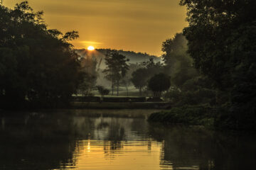The sun rises over a misty Royal Chiang Mai Golf Club