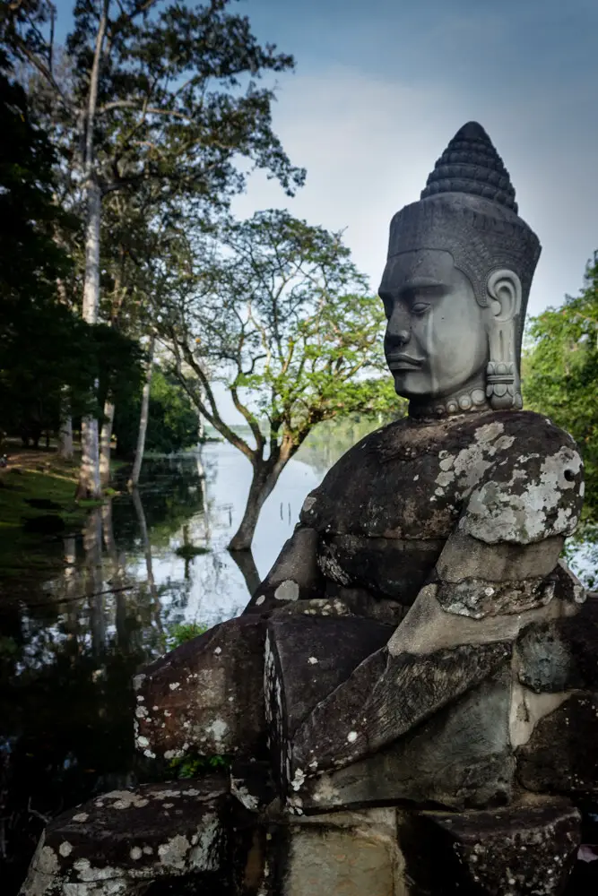 Khmer sculpture at Angkor with river backdrop