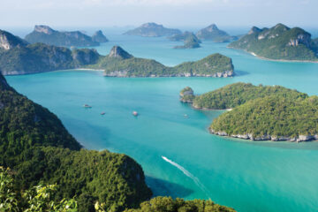 Tropical islands dotted around in a turquoise sea. Supplied by https://press.fourseasons.com/