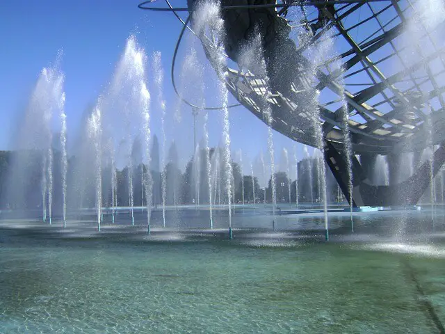 Huge metal globe among dozens of fountains