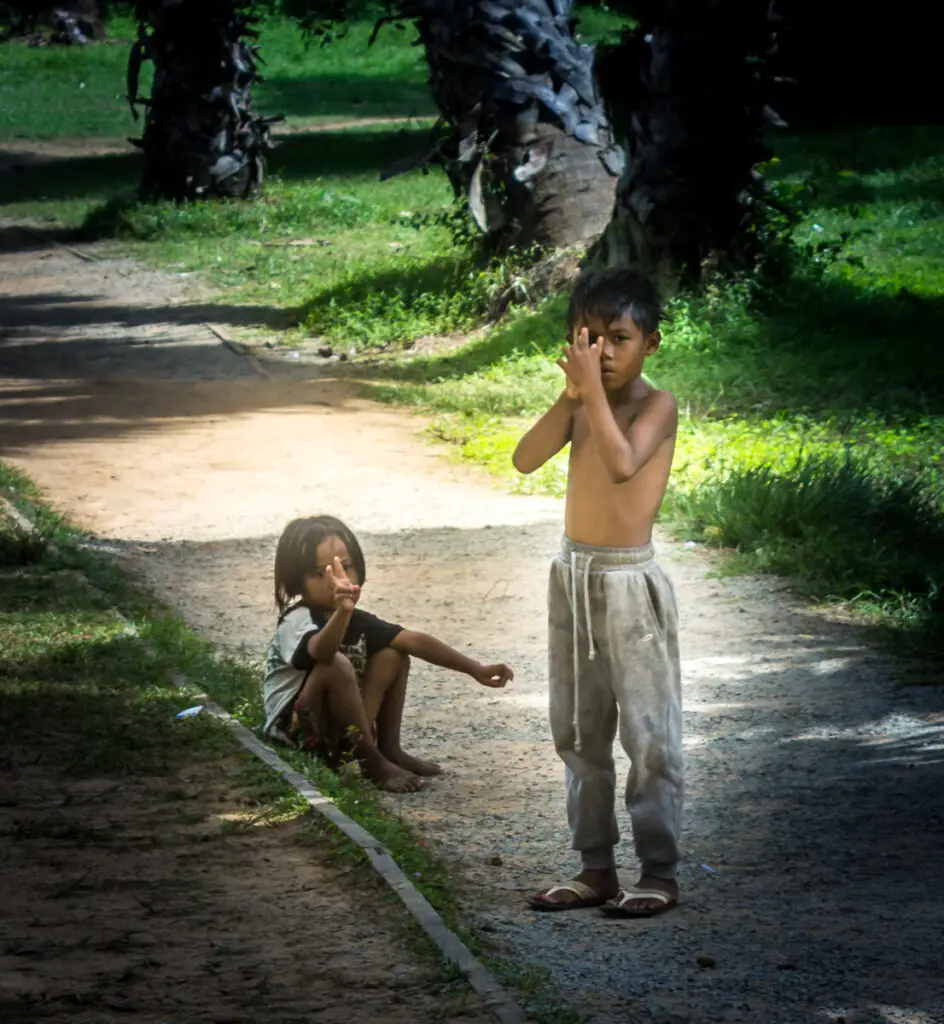 2 cambodian children under the trees at Angkor Wat